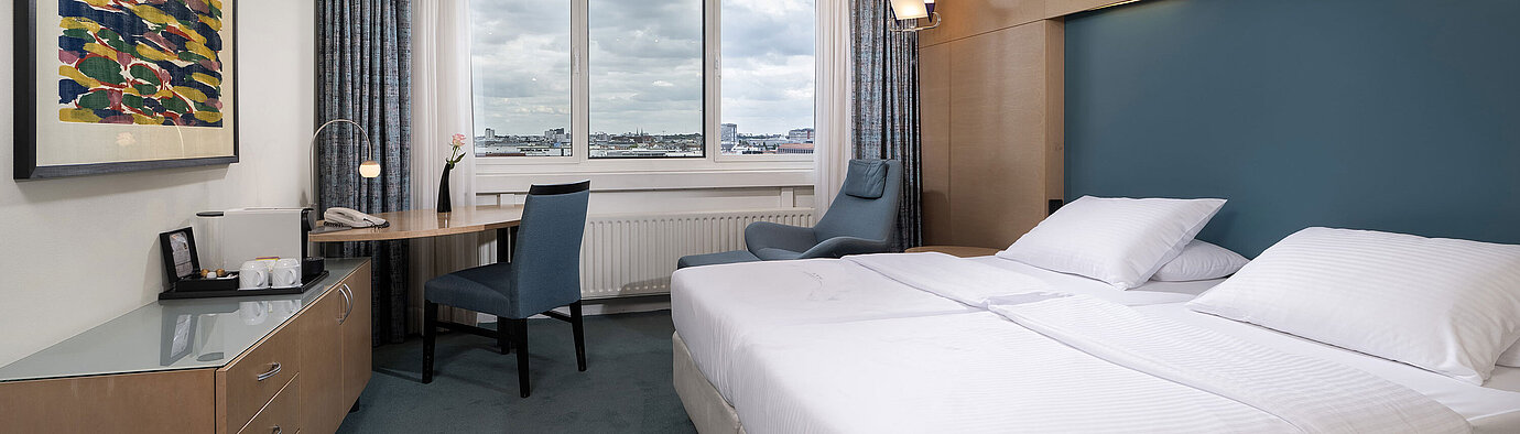Superior room with double bed, desk, armchair and wide Berlin view at Maritim proArte Hotel