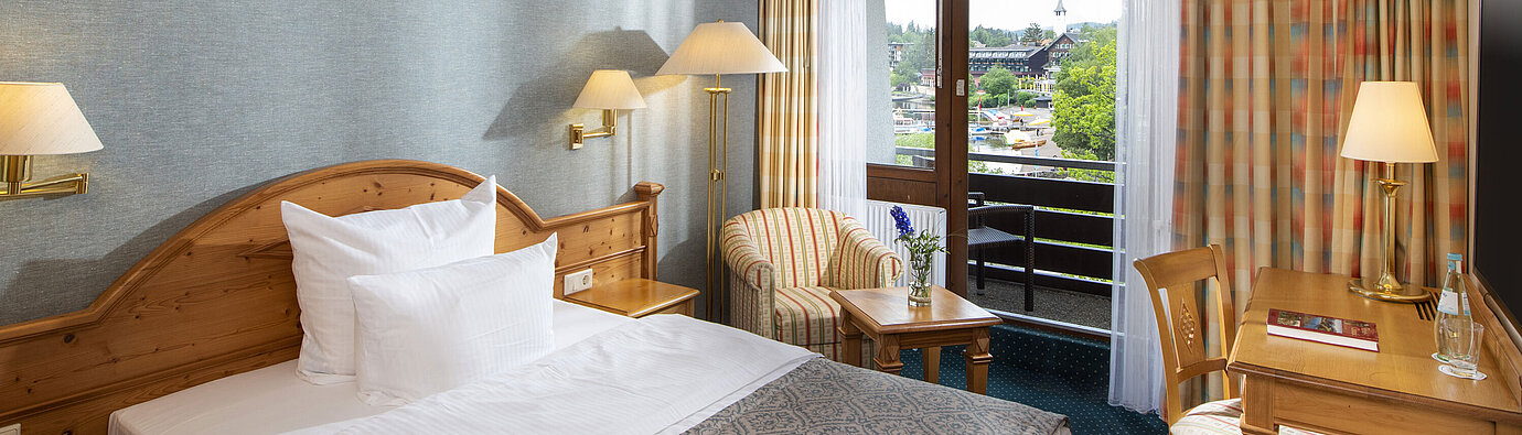 Single room at Maritim TitiseeHotel with balcony and view of Titisee and village