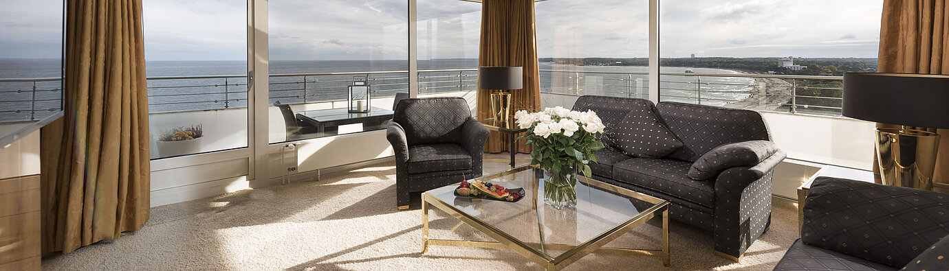 Penthouse living room with panoramic windows and sea view at Maritim Seehotel Timmendorfer Strand.