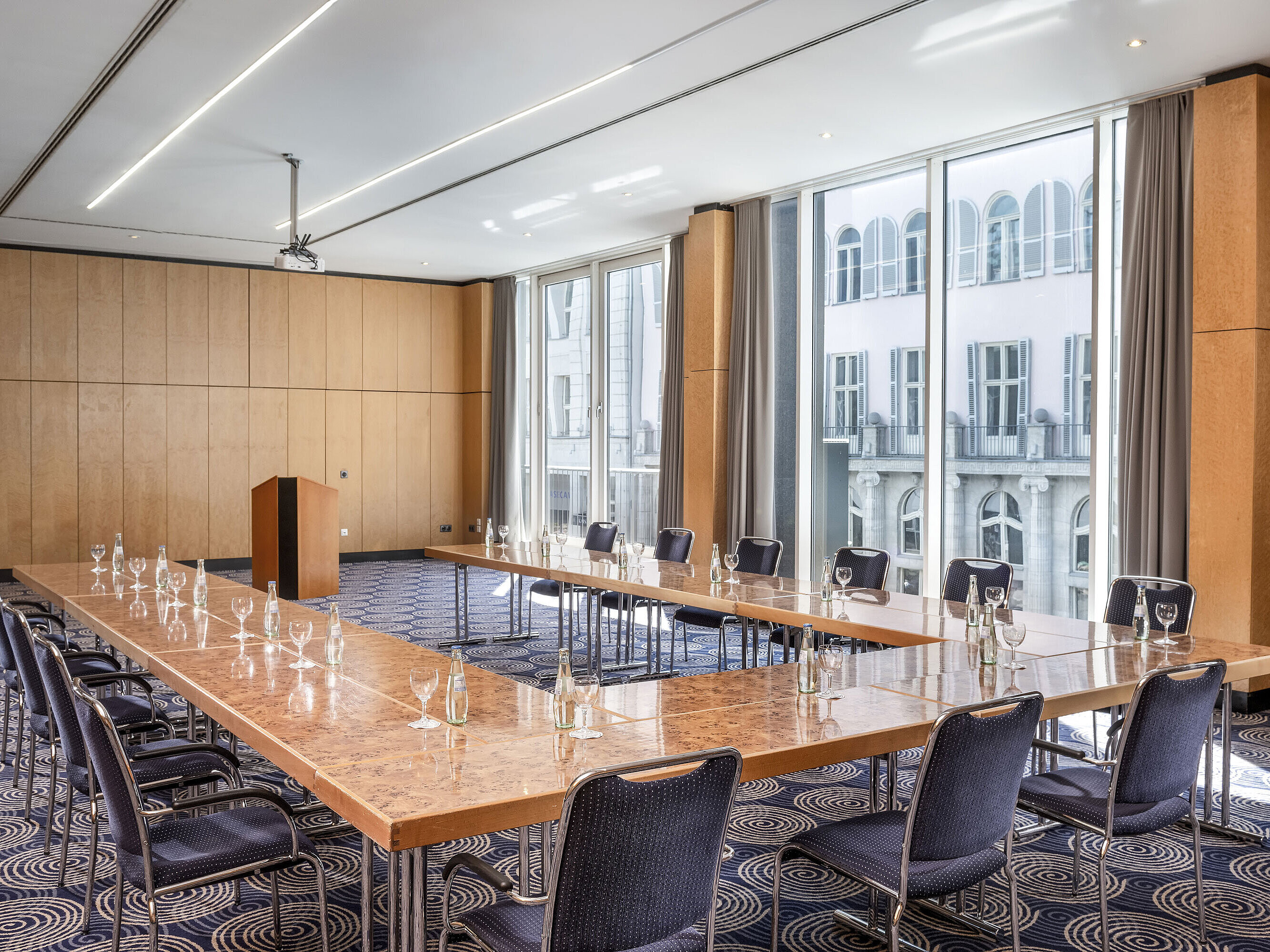 Conference room Salon II at Maritim proArte Hotel Berlin, large U-shaped table with outside view.
