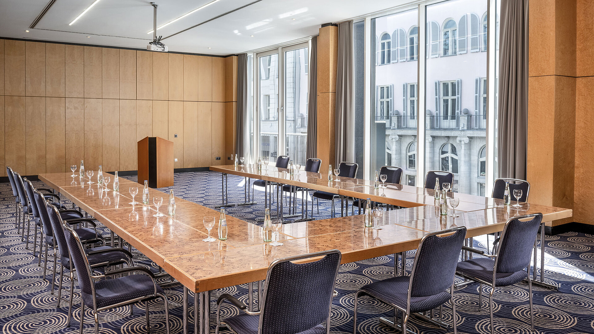 Conference room Salon II at Maritim proArte Hotel Berlin, large U-shaped table with outside view.