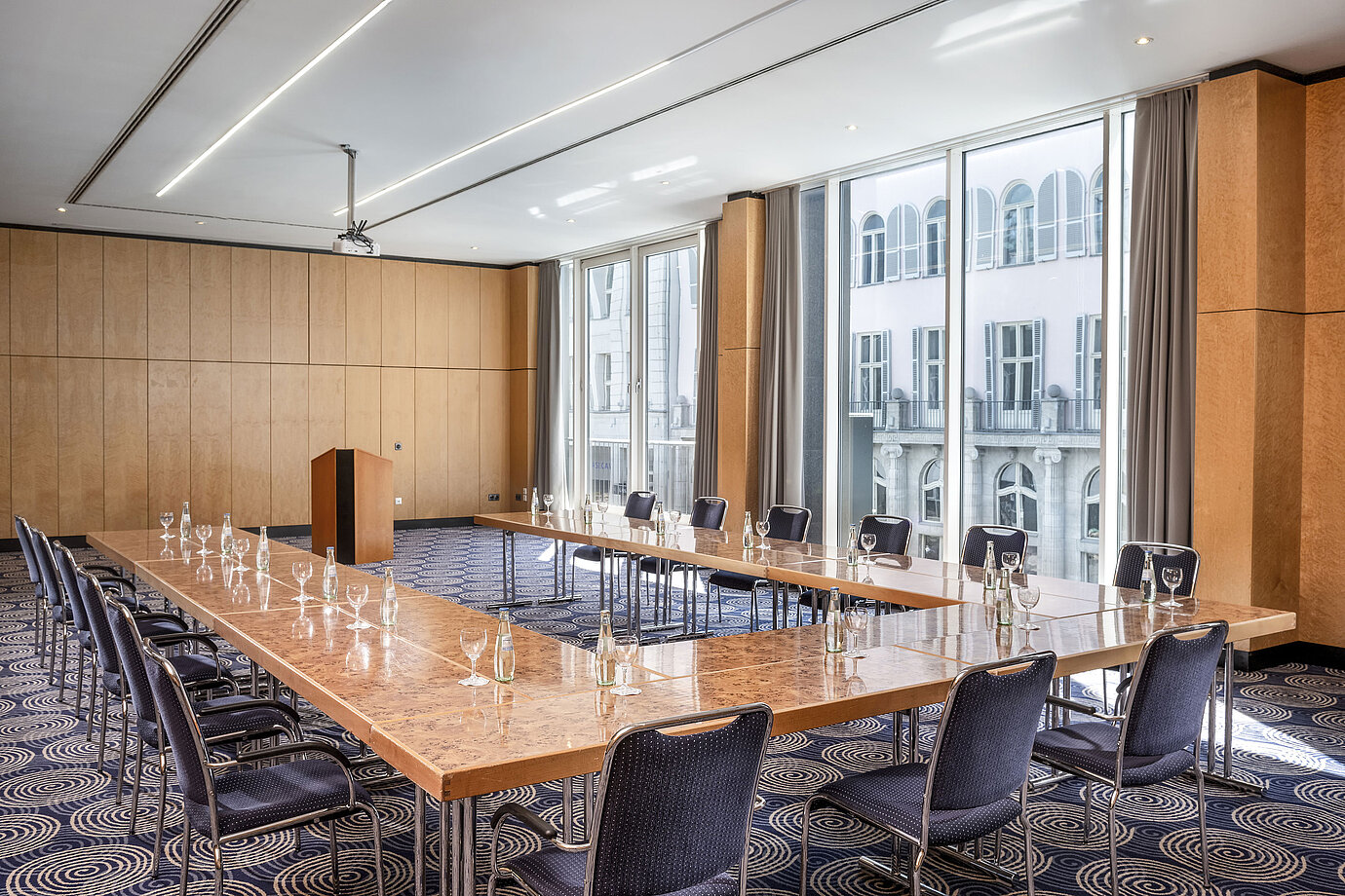 Conference room Salon II at Maritim proArte Hotel Berlin, large U-shaped table with outside view.