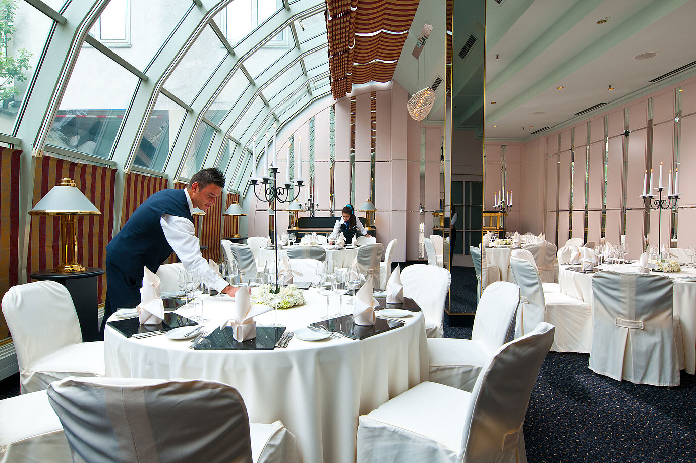 Elegantly set room for banquets and celebrations with glass roof at Maritim Hotel Munich