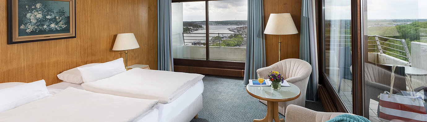 Double room with panoramic windows and view of Travemünde harbour at the Maritim Hotel