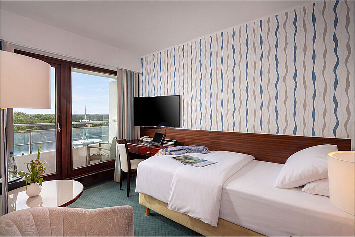 Classic Single room with single bed, seating area, television and large window with a view