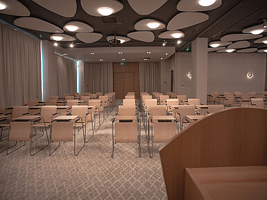 Modern conference room with row seating, bright lighting and stylish acoustic ceiling panels