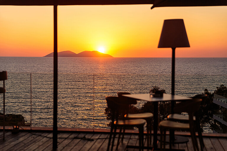 Sunset over the sea at Maritim Resort Marina Bay with terrace view of islands and water