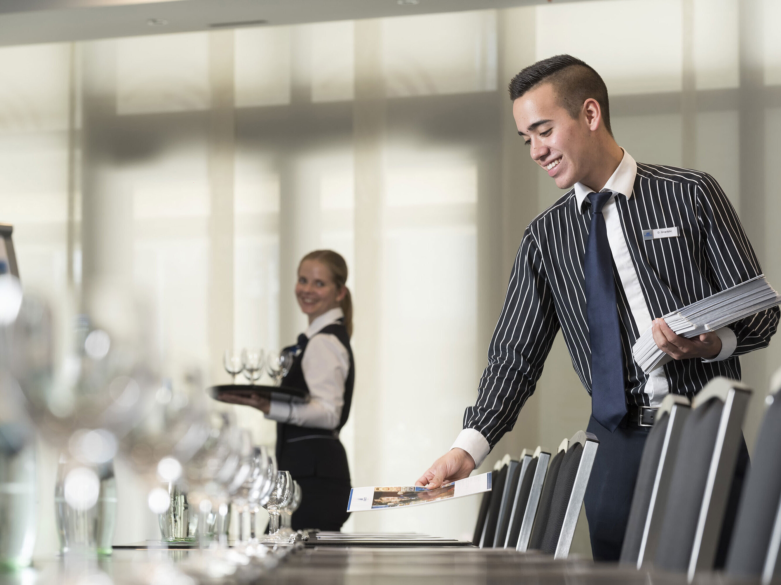 Friendly service team at Maritim Hotel Bad Homburg preparing conference room.