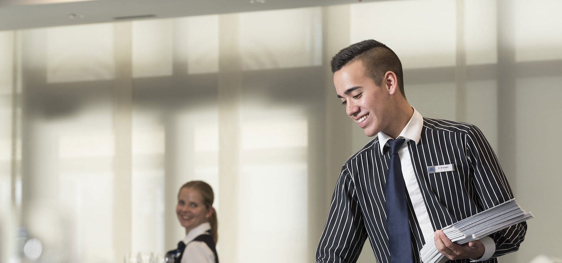 Friendly service team at Maritim Hotel Bad Homburg preparing conference room.