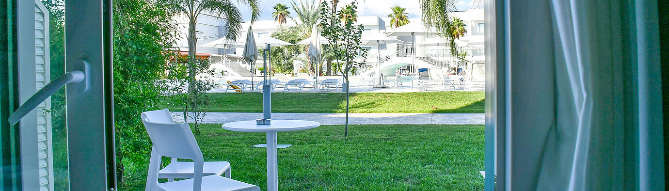 Private terrace on the ground floor of Maritim Resort Calabria with view of greenery and pool