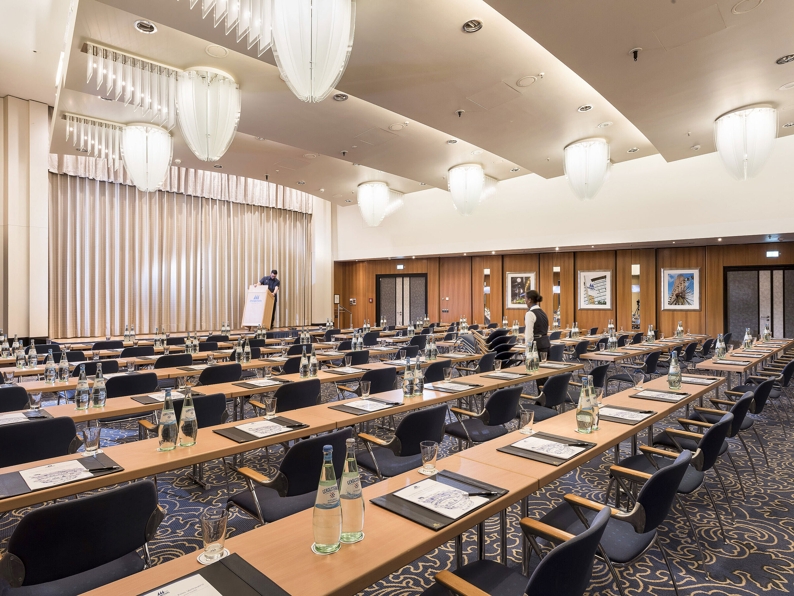  Large conference room at Maritim Hotel Frankfurt with row seating, stage, and modern facilities. 