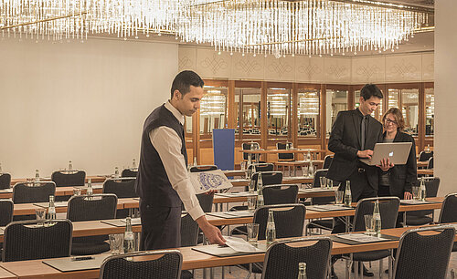 Staff preparing meeting room with chandeliers at the Maritim Hotel Munich