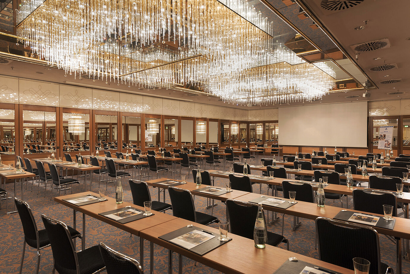 Spacious conference hall with chandeliers and professional setup at the Maritim Hotel Munich