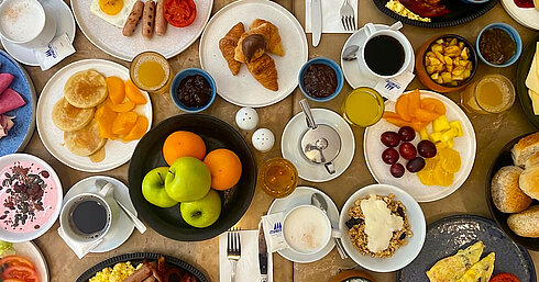 Extensive breakfast at Les Jardins Restaurant at Maritim Antonine Hotel & Spa Malta featuring egg dishes, pancakes, croissants, fruit, yoghurt, granola, juices and coffee.