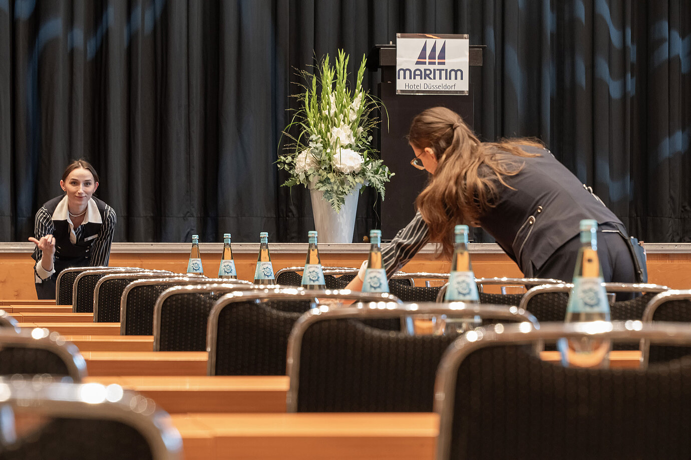 Staff prepare conference room with stage at Maritim Hotel Düsseldorf