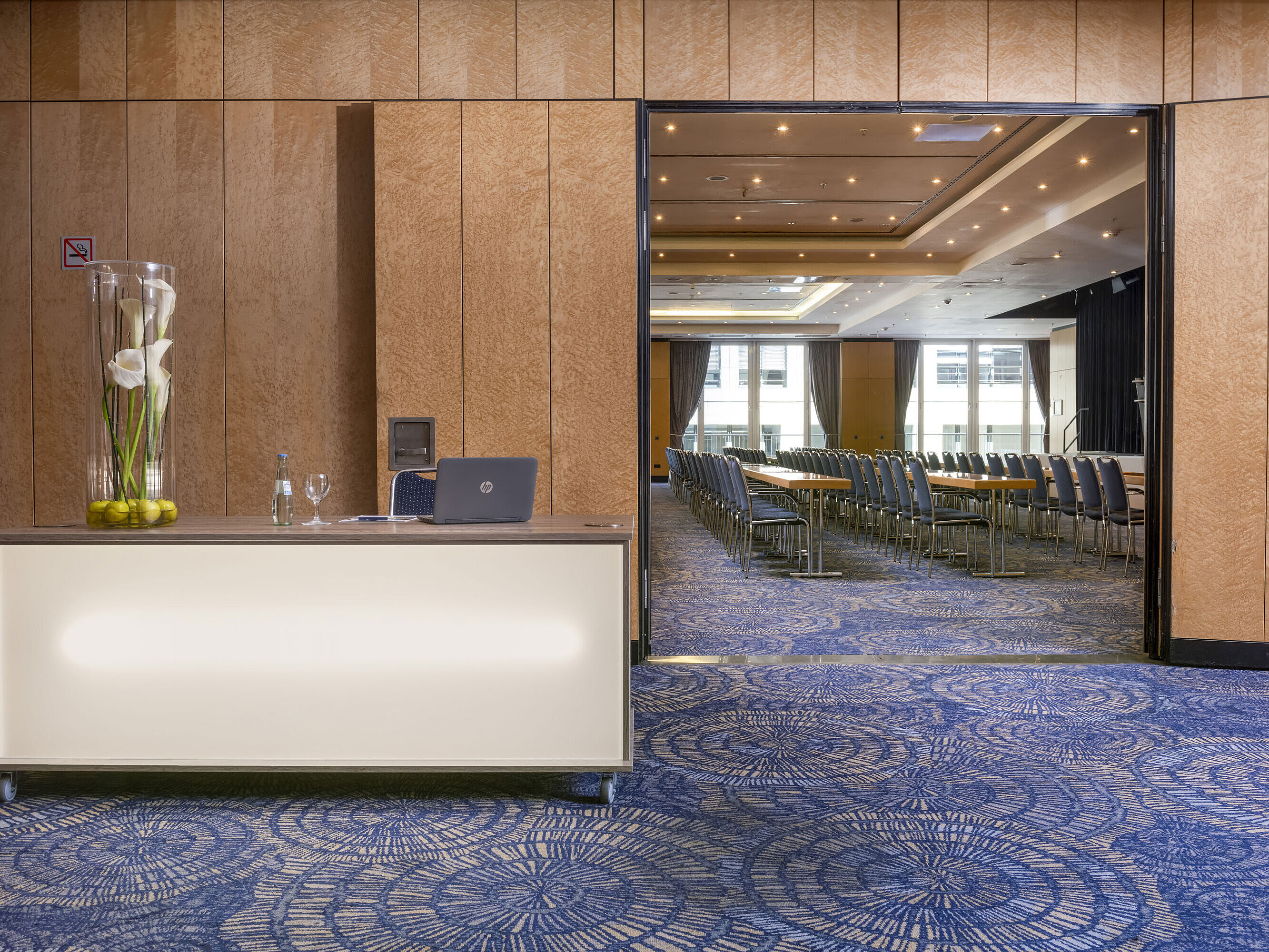 Elegant event reception area with desk at Maritim proArte Hotel Berlin, view into the conference room.