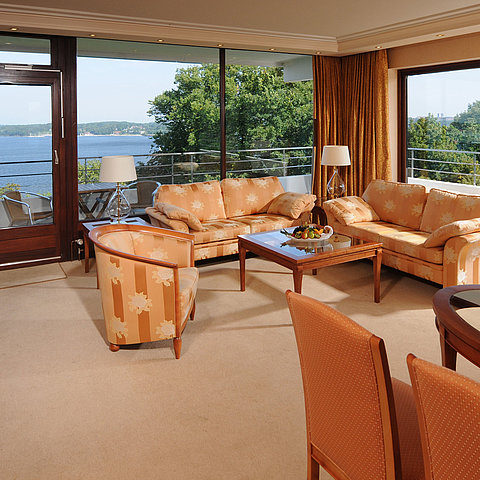 Presidential suite in the Maritim Hotel Kiel, spacious living area with sofas, balcony and view of the Kiel Fjord.