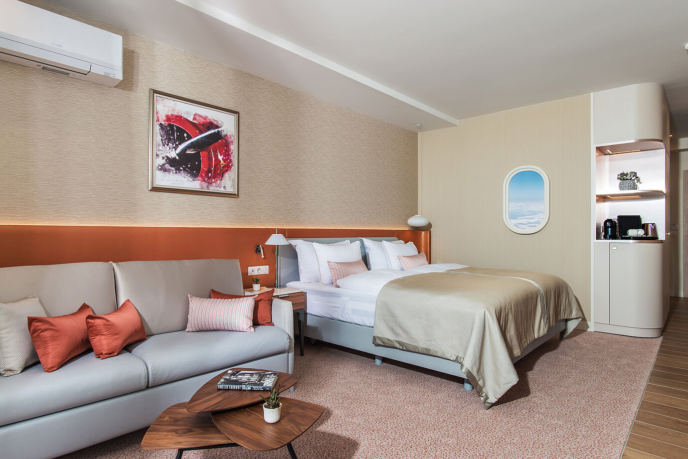 Modern room at Maritim Hotel Amelia with cosy sofa, large bed and stylish details