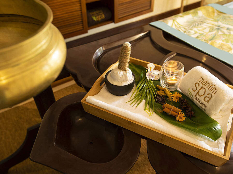 Spa accessories with herbal compresses, towel, candle and natural ingredients for relaxing treatments