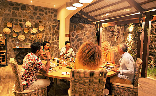Group of guests enjoying dinner together in a warm atmosphere