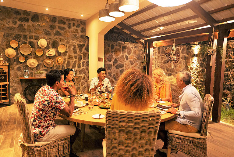 Group of guests enjoying dinner together in a warm atmosphere