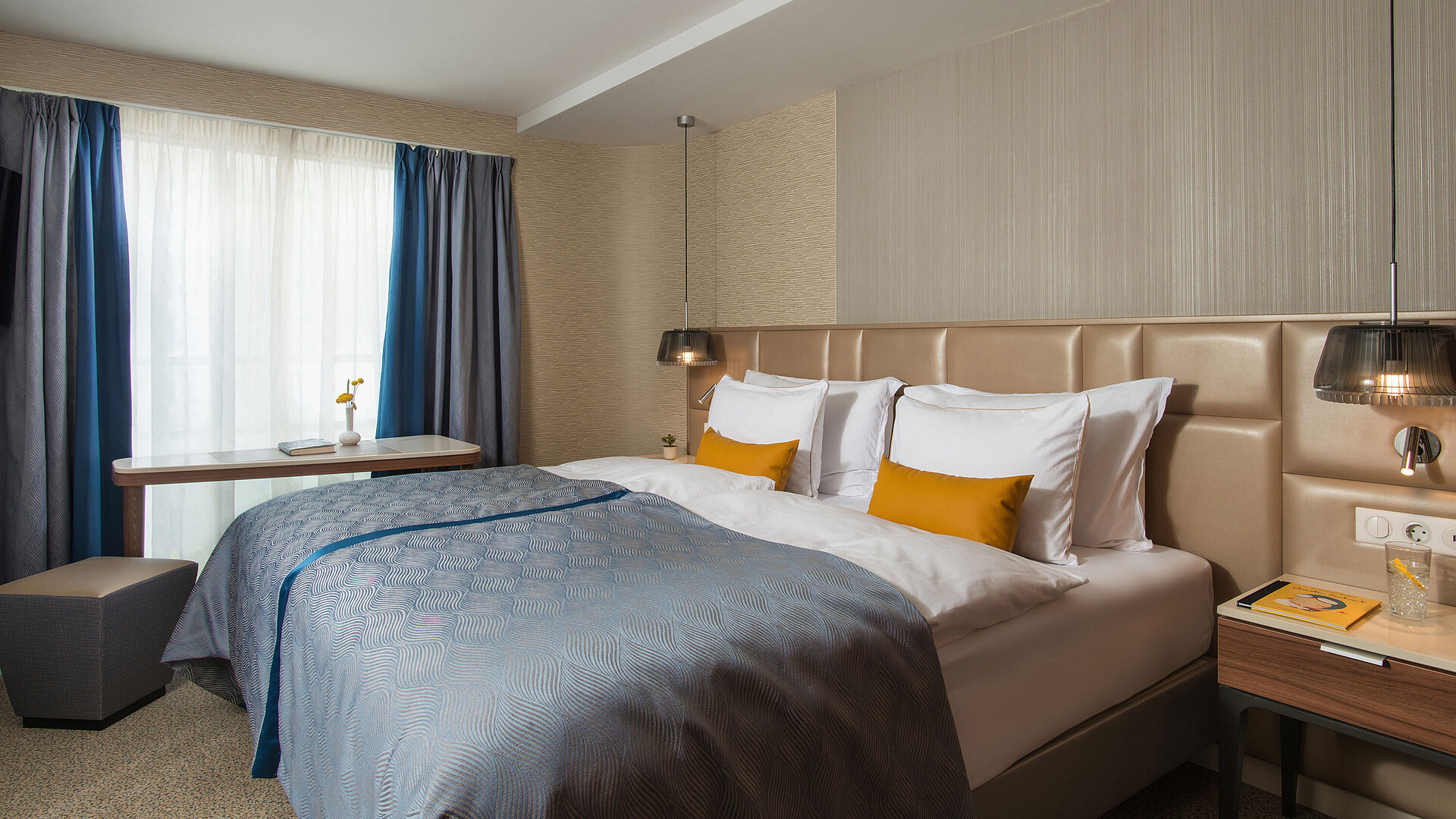 Bright double room at Maritim Hotel Amelia with blue bedspread, modern lighting and cosy atmosphere