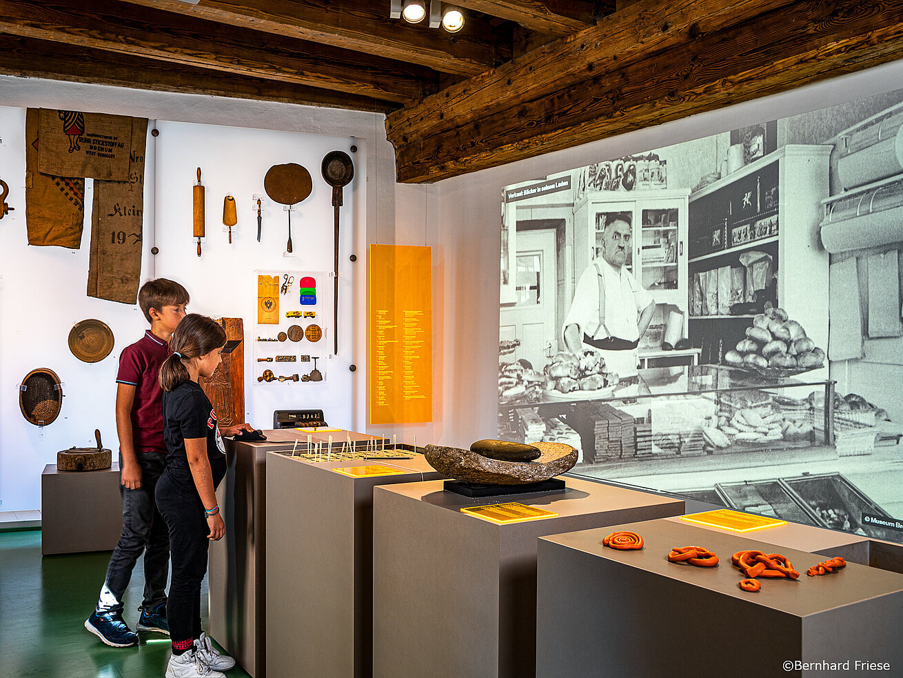 Children exploring historical exhibits in a museum.