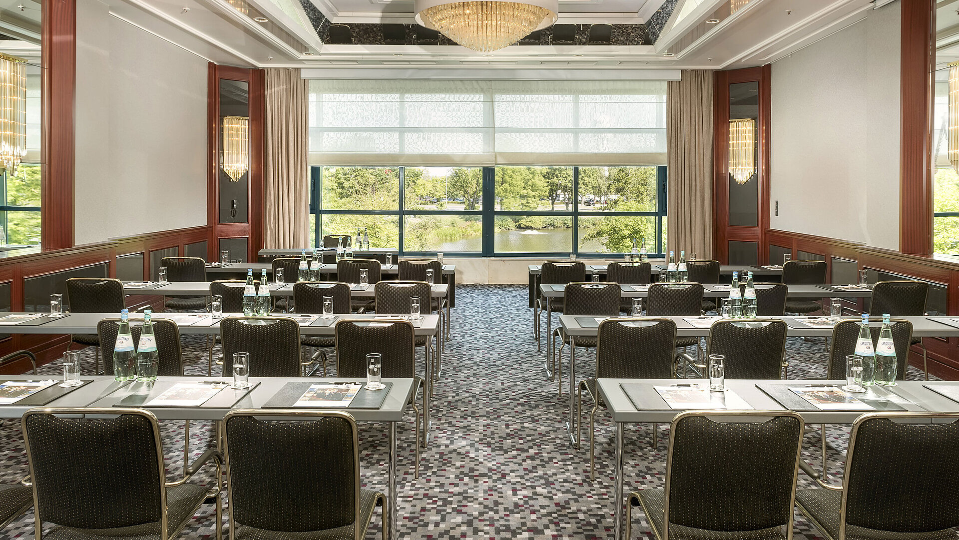 Modern conference room at Maritim Hotel Hannover with elegant design, natural light, and a green view.