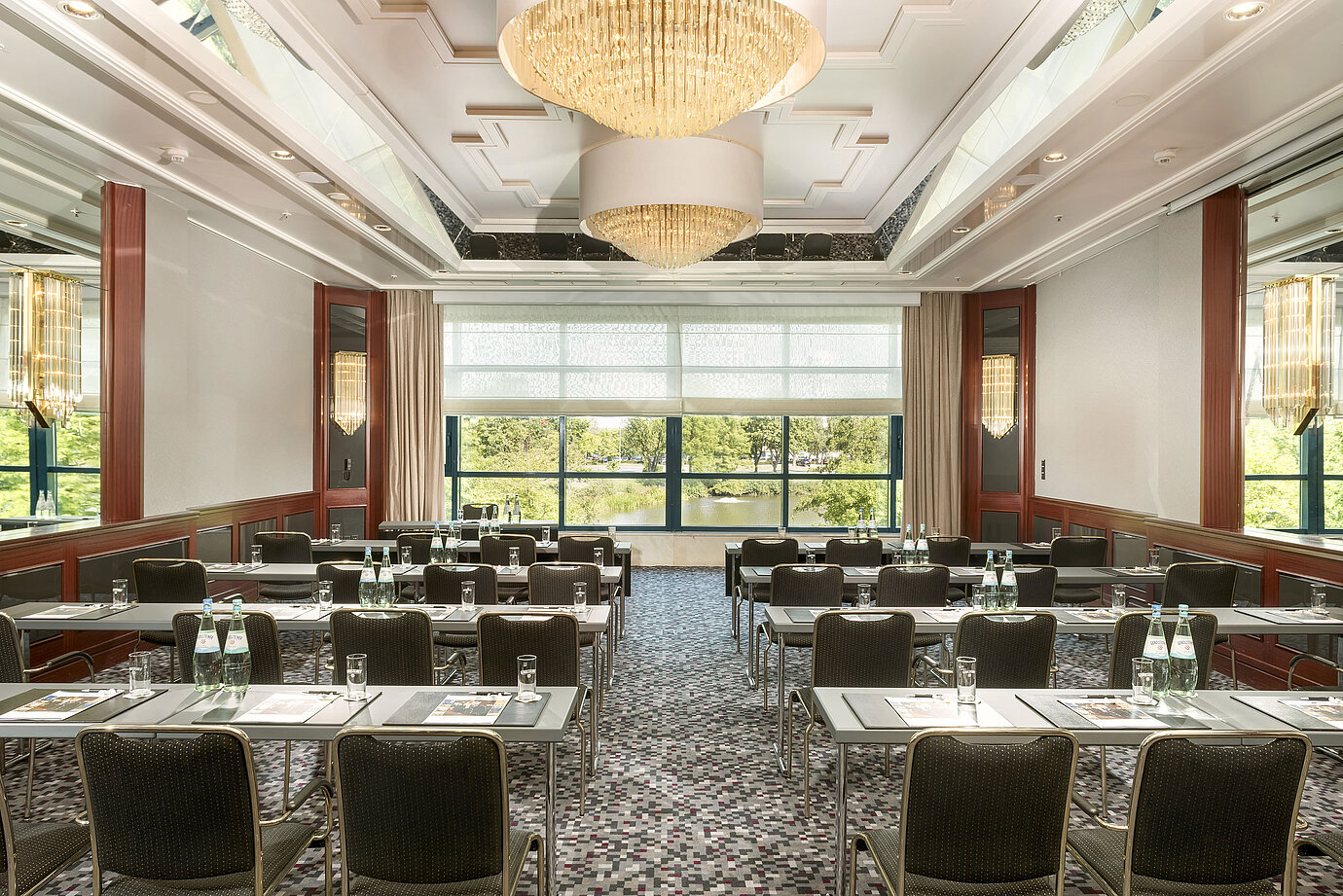 Modern conference room at Maritim Hotel Hannover with elegant design, natural light, and a green view.