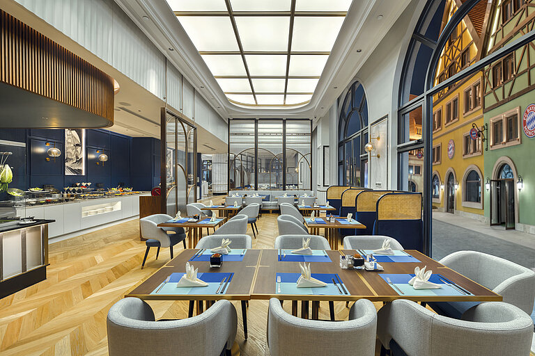 Bright restaurant with modern design, buffet area and elegant seating at Maritim Hotel Taicang