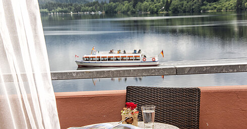 Balcony with lake view and passing boat on Lake Titisee at Maritim TitiseeHotel
