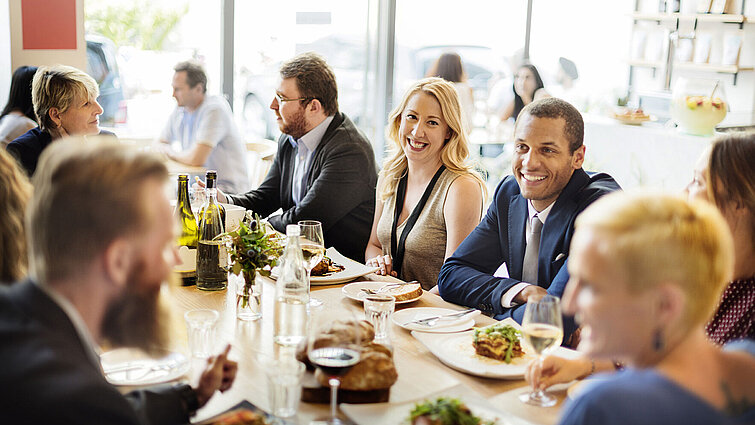 Business people and friends enjoying a relaxed lunch together at a restaurant