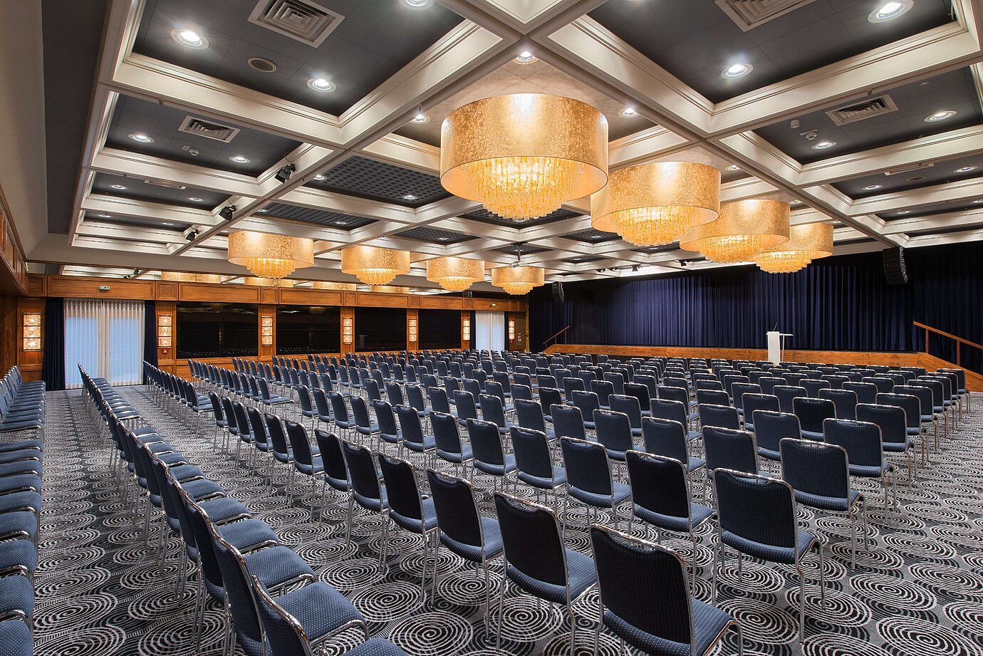 Elegant hall at Maritim Hotel Darmstadt featuring row seating, stunning chandeliers, and perfect setup for events.