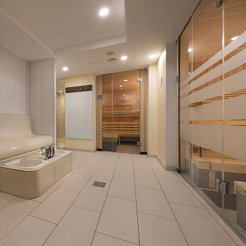 Modern sauna area at Maritim Hotel Königswinter with relaxing foot bath and stylish design.