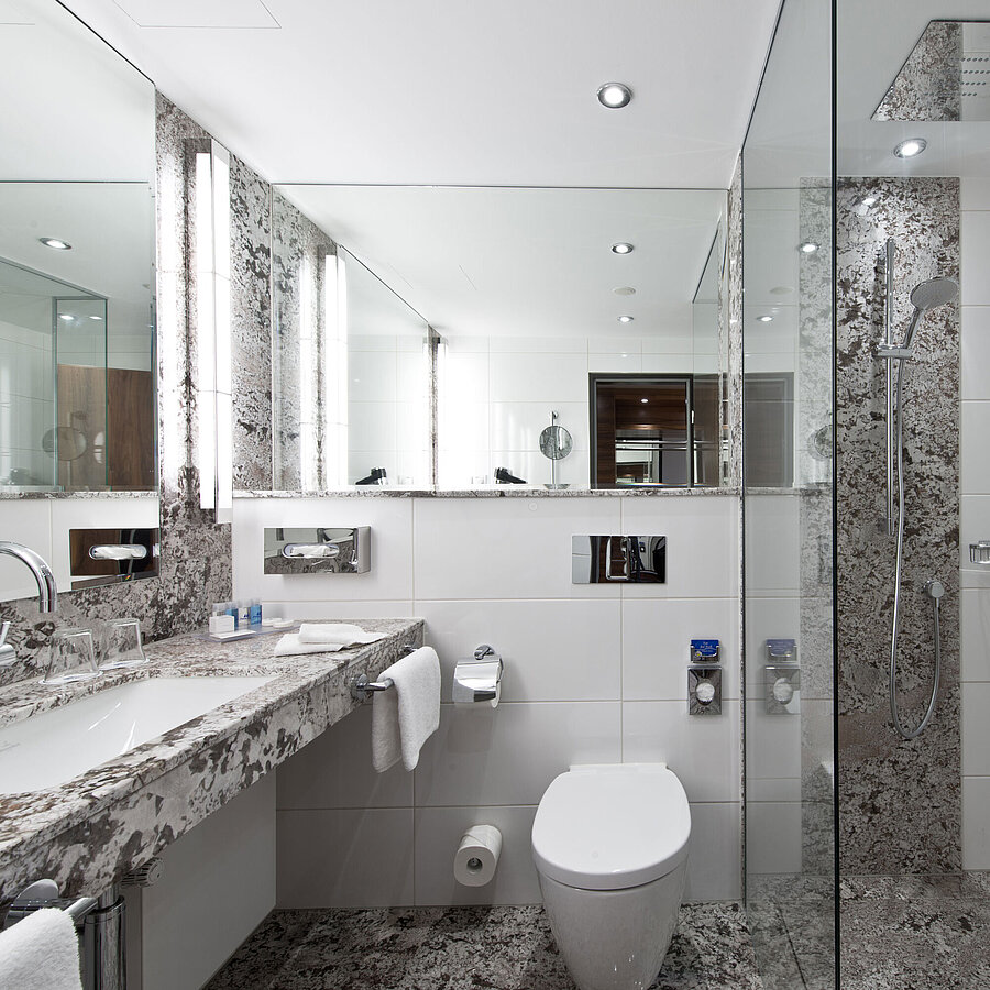 Modern bathroom at Maritim Hotel Bad Homburg with elegant rain shower and stylish marble design.