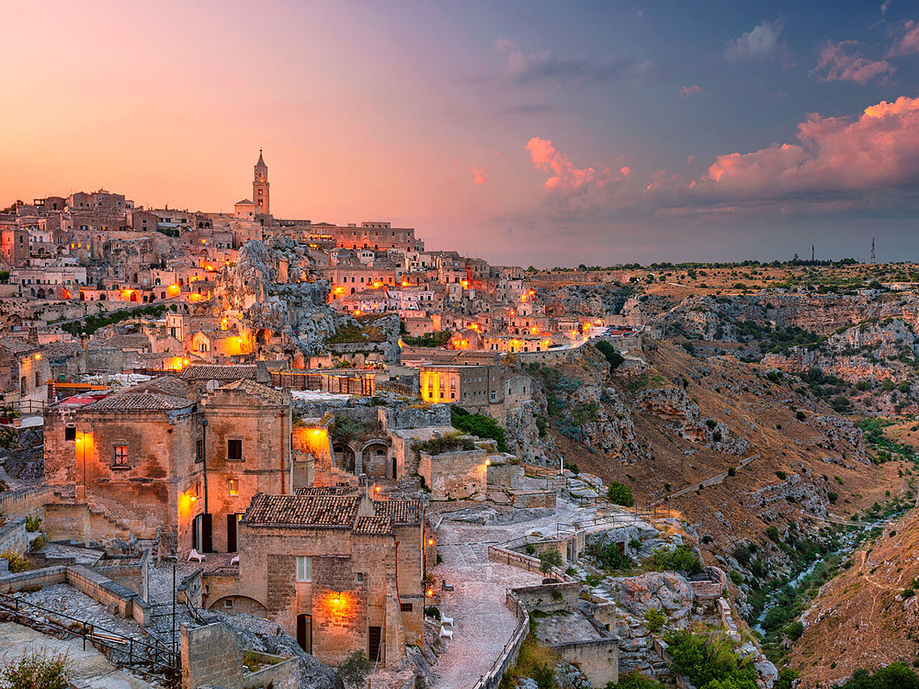 Historic old town of Matera in Italy with ancient cave houses at sunset