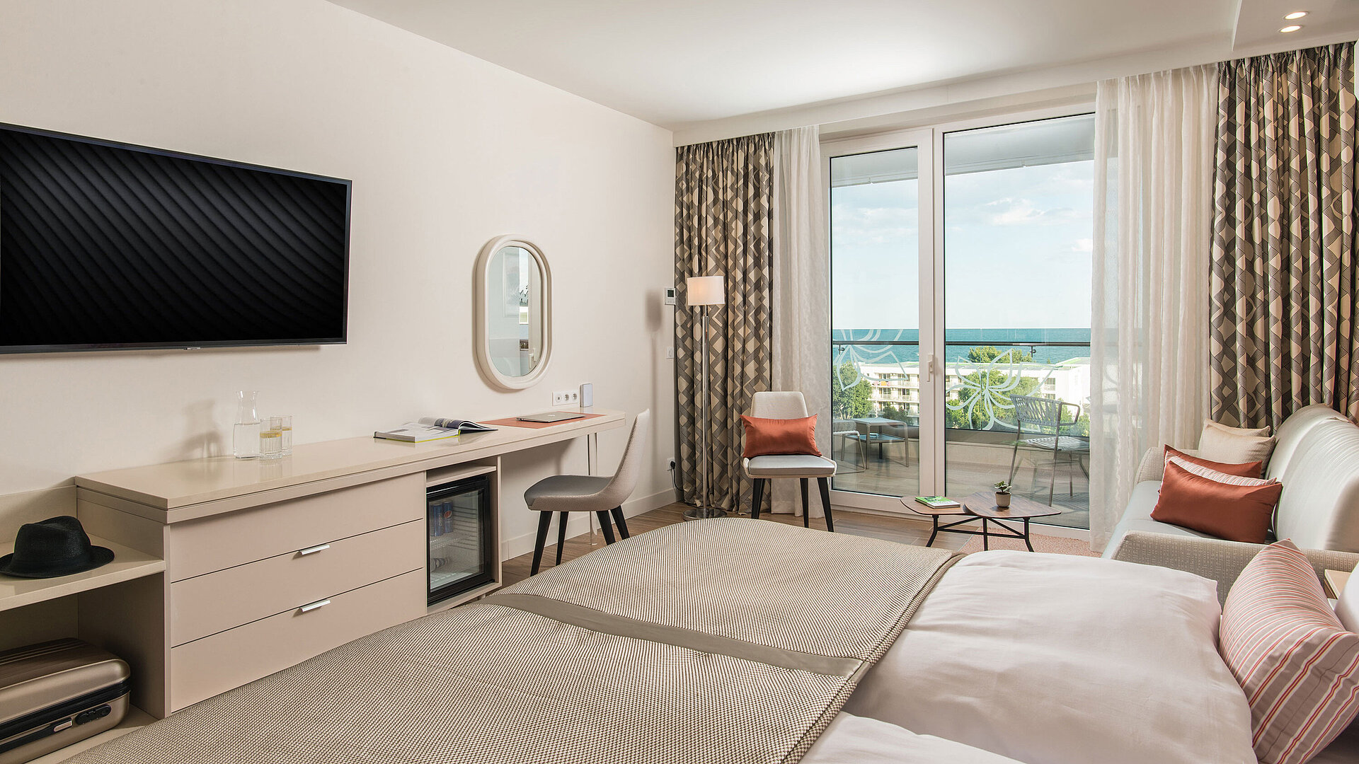 Bright room at Maritim Hotel Amelia with desk, seating area and balcony view of the sea
