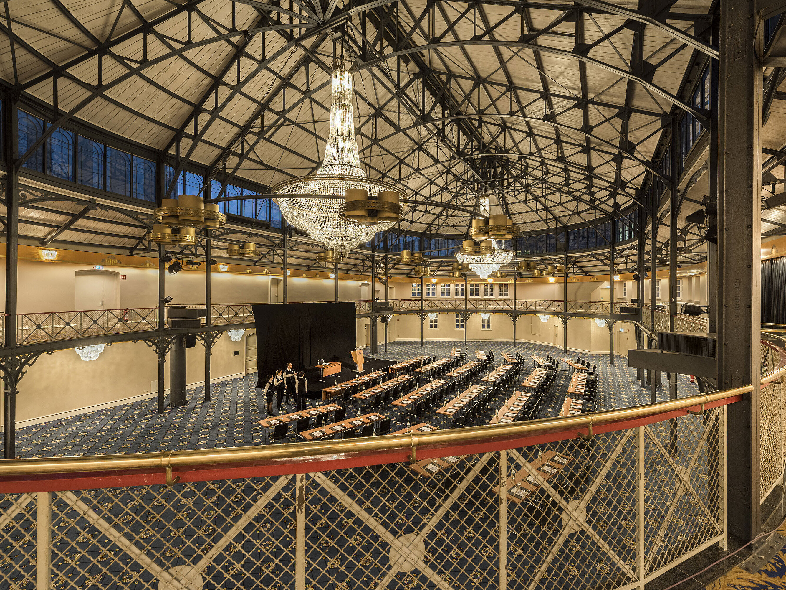 Historic riding hall with stage, chandeliers and seating rows at Maritim Hotel Stuttgart