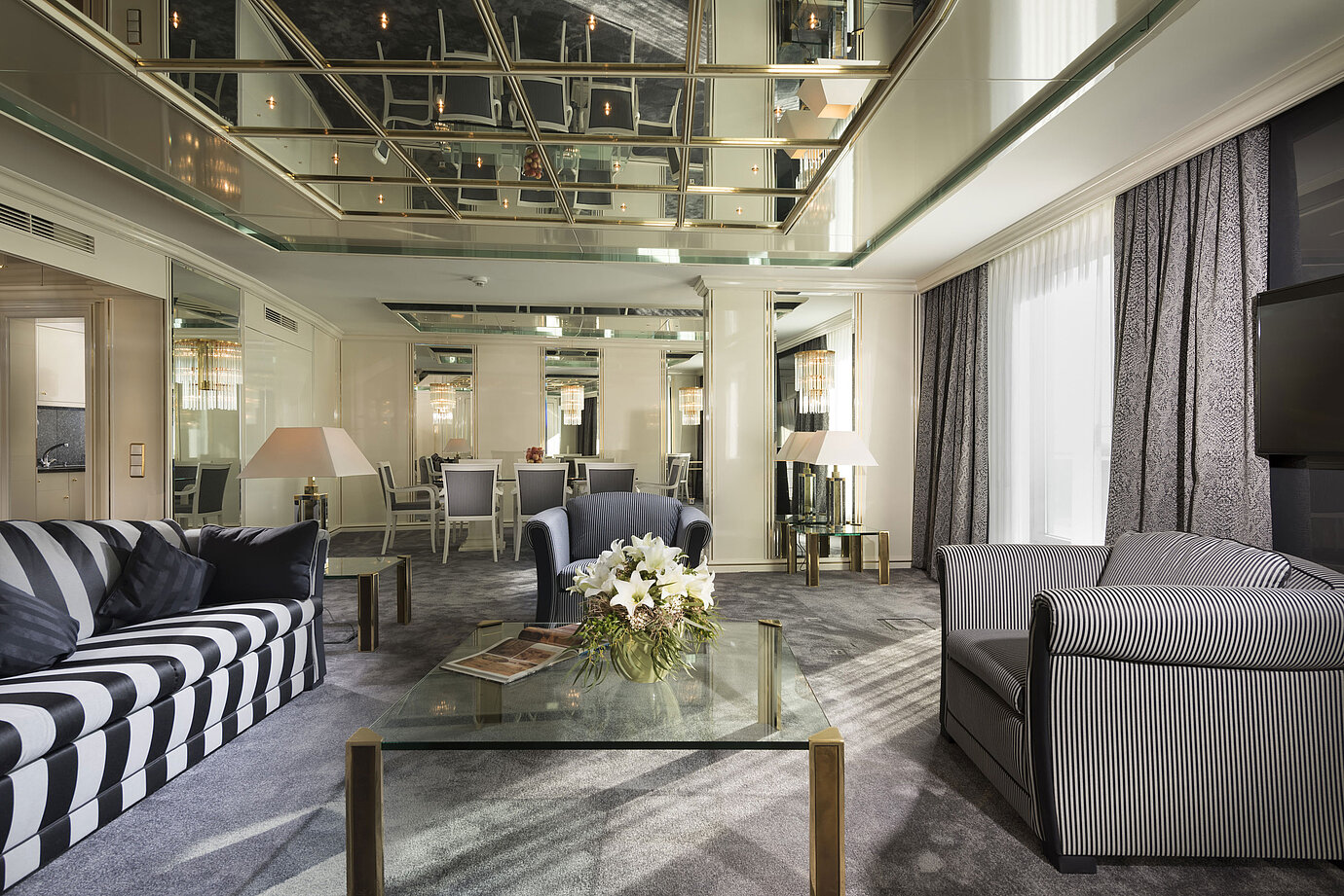 Luxury suite at Maritim Hotel Ulm with mirrored ceiling, elegant lounge and dining table