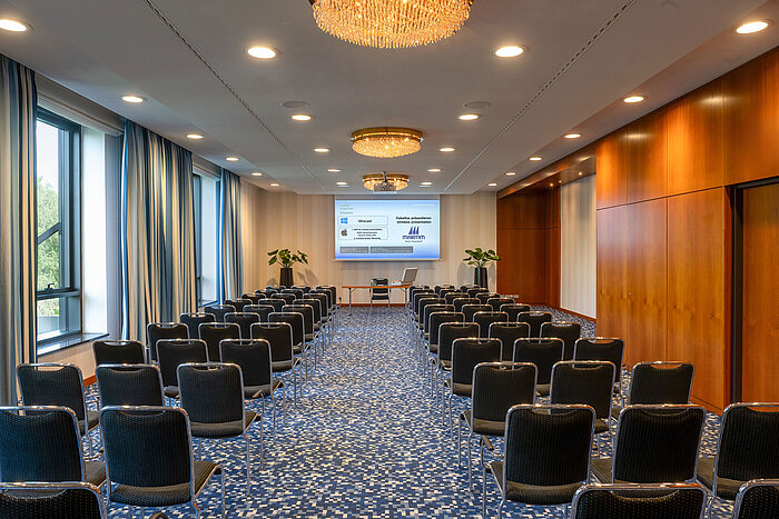 Modern conference room with row seating and presentation area at Maritim Hotel Düsseldorf