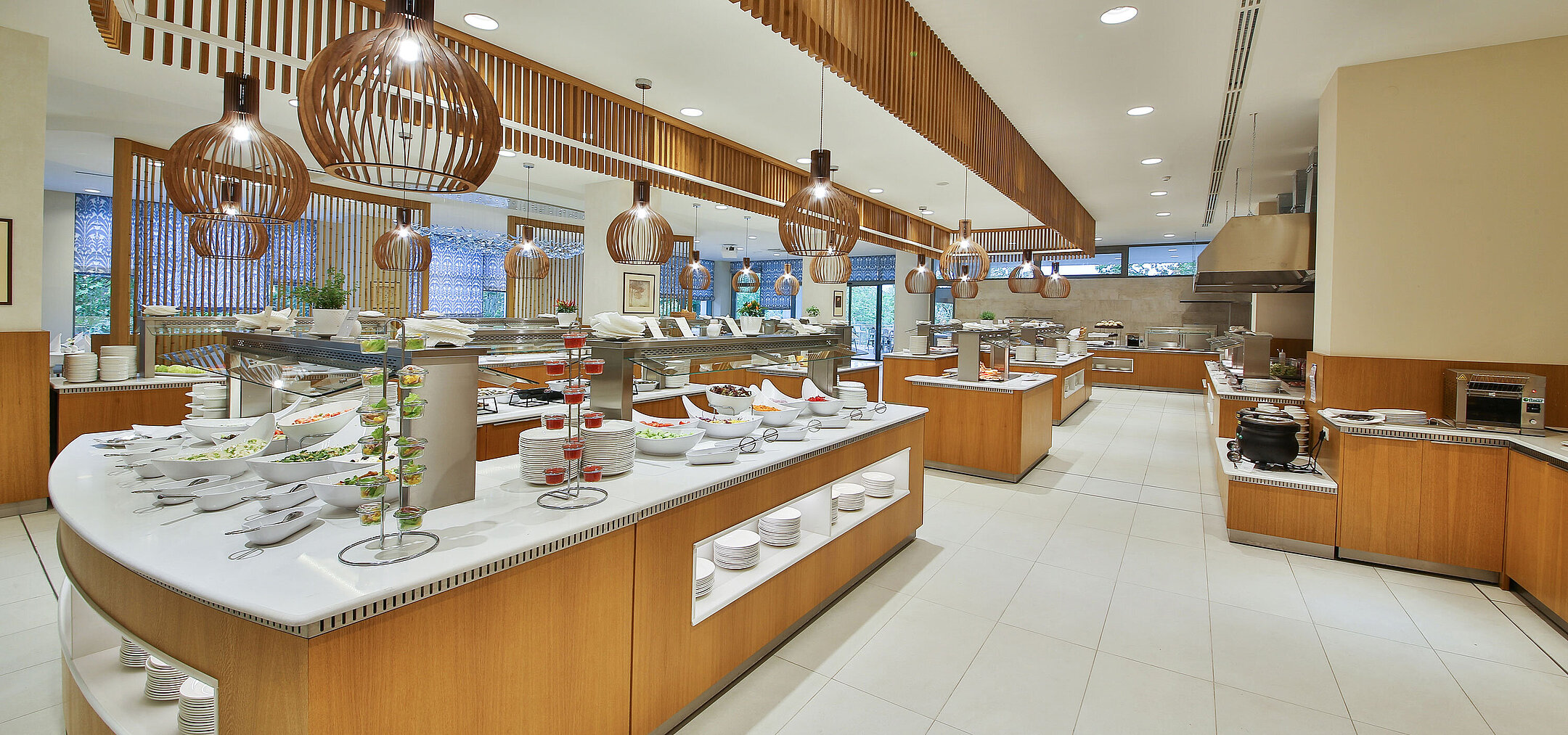 Large buffet restaurant with a wide selection, modern wooden accents and spacious food stations