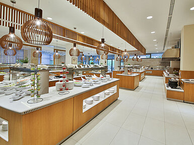 Large buffet restaurant with a wide selection, modern wooden accents and spacious food stations