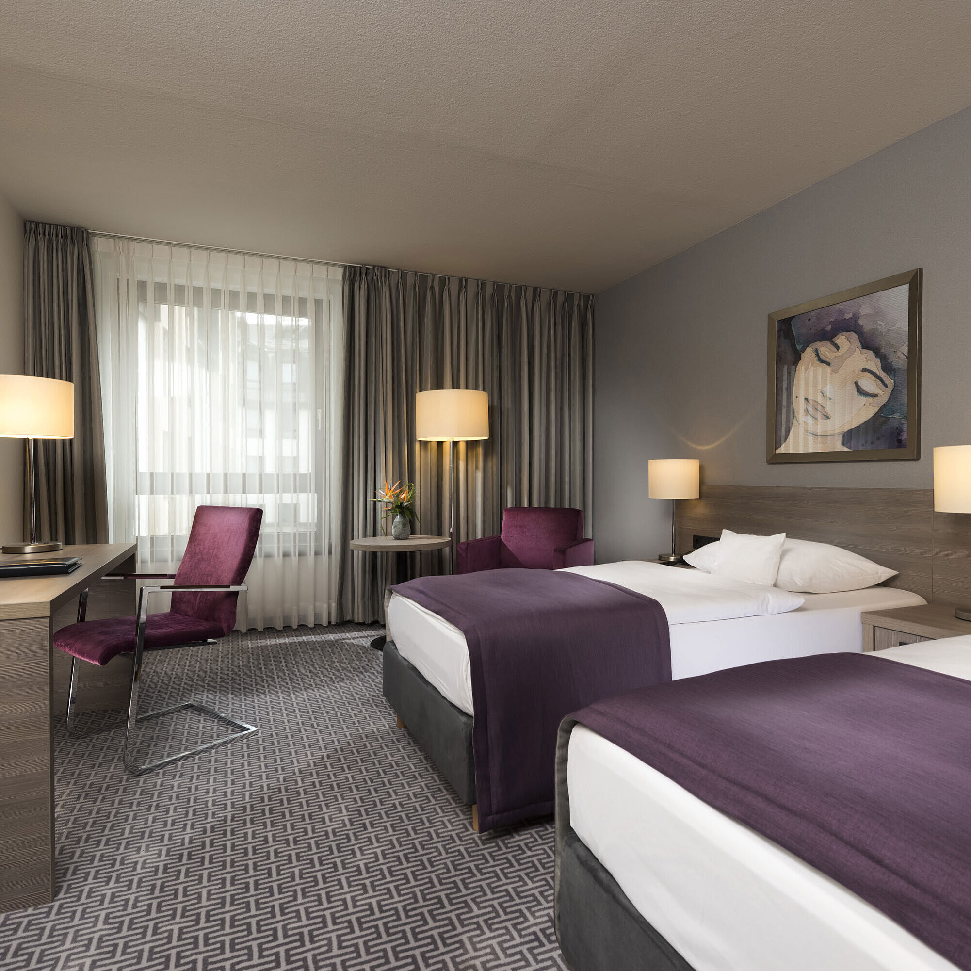 Modern twin room at Maritim Hotel Königswinter with two beds, desk, and stylish decor.