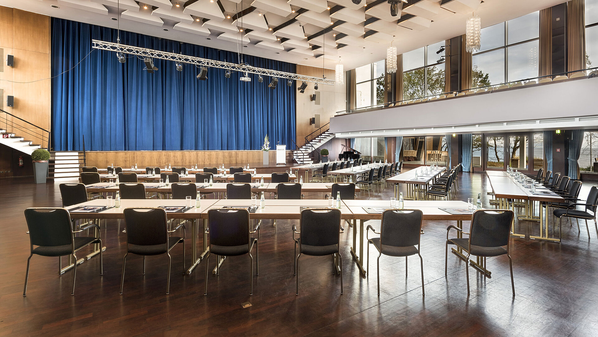 Grand Hall "Maritim" at Maritim Seehotel Timmendorfer Strand with stage, blue curtains, and conference seating.