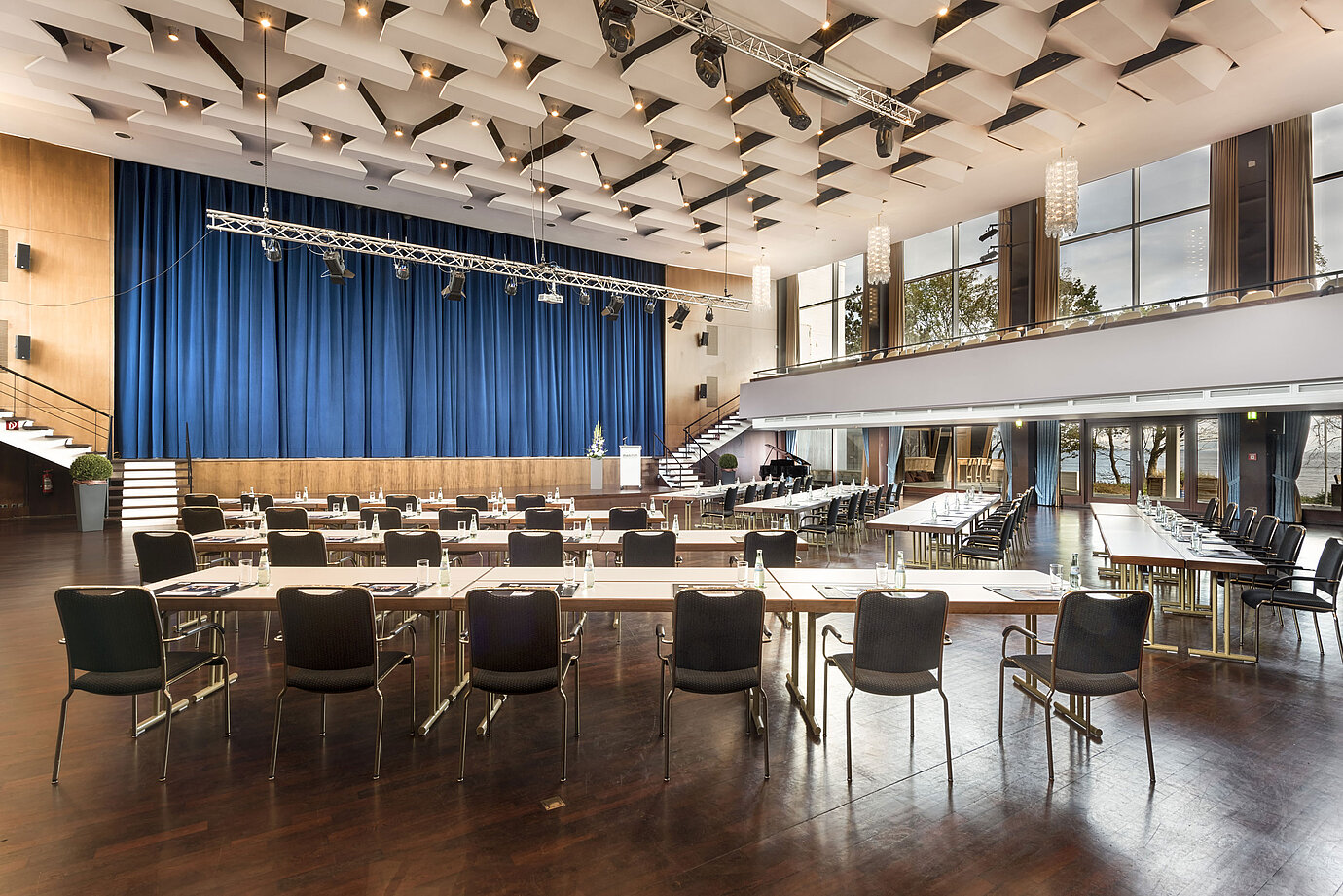Grand Hall "Maritim" at Maritim Seehotel Timmendorfer Strand with stage, blue curtains, and conference seating.