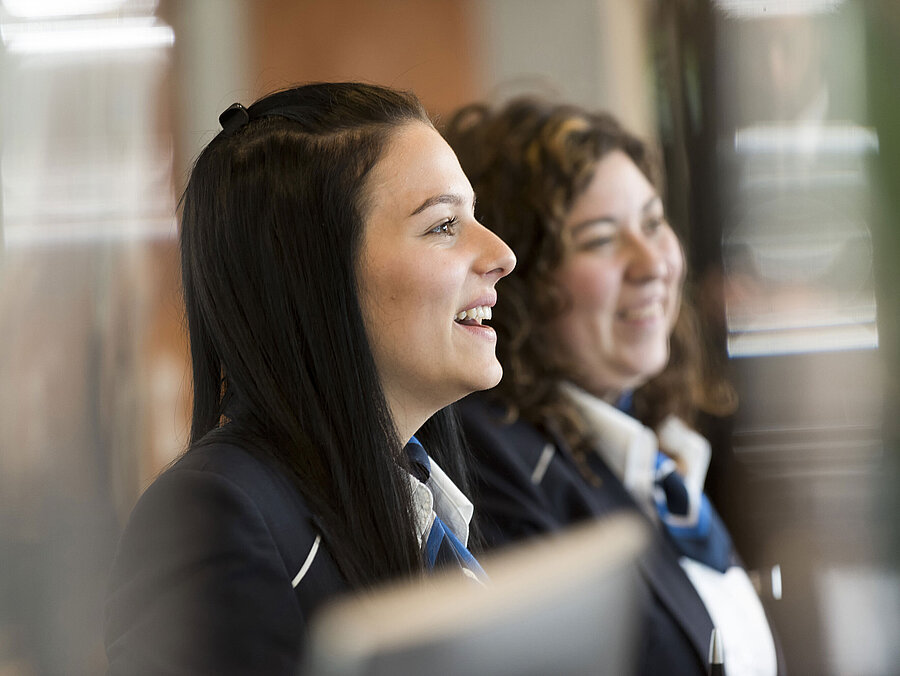 Smiling reception staff at Maritim Hotel Frankfurt welcoming guests.