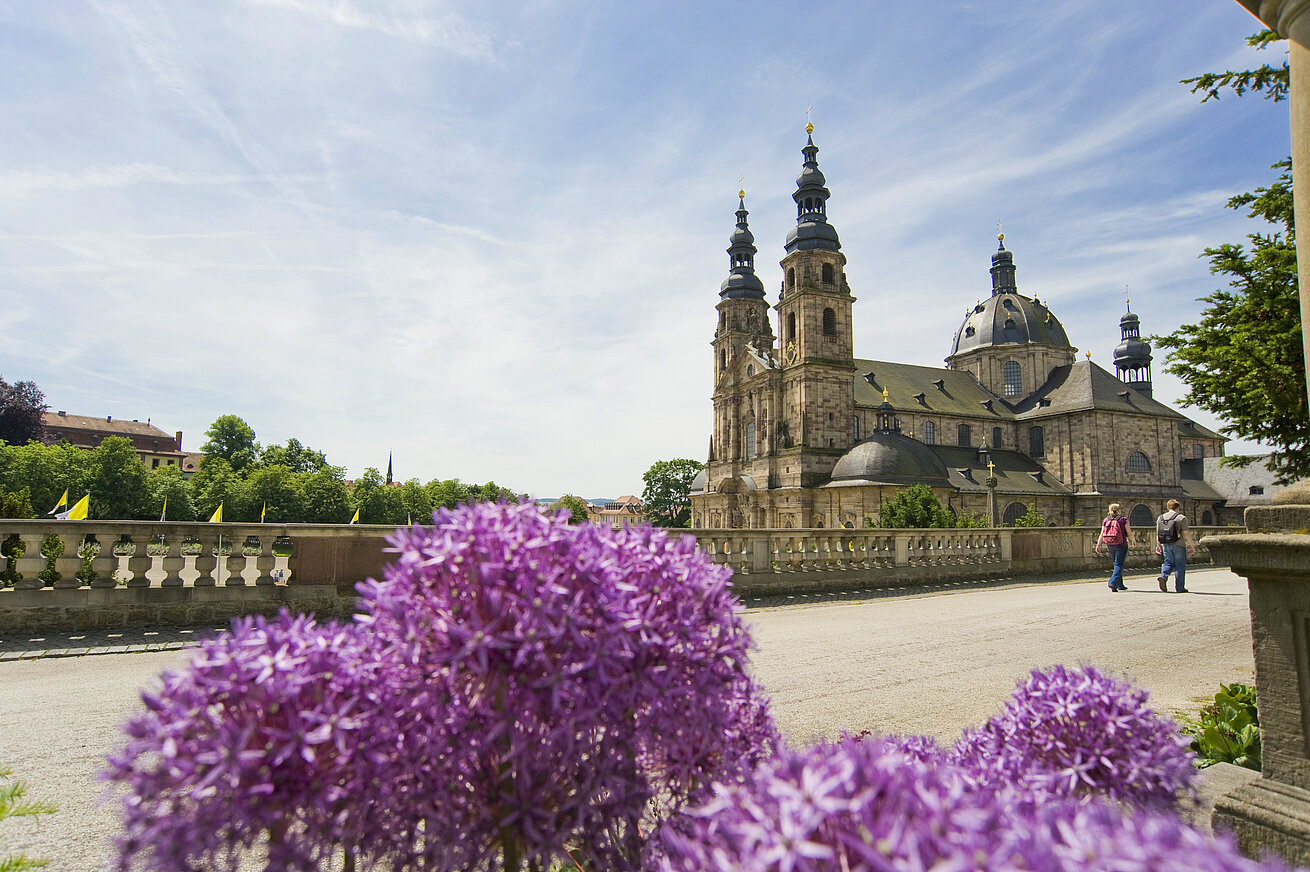 Fulda Cathedral in spring with blooming allium flowers in the foreground