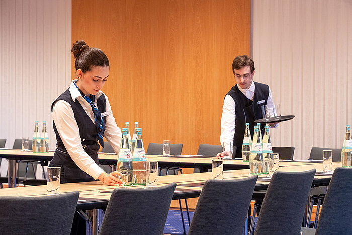 Hotel staff preparing a meeting room at Maritim Hotel Würzburg for an event