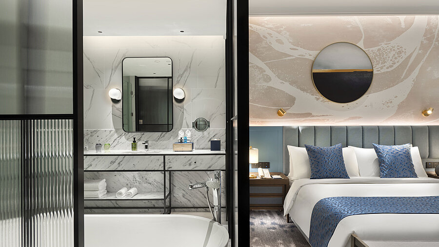 Modern bedroom with open marble bathroom and elegant details at Maritim Hotel Taicang