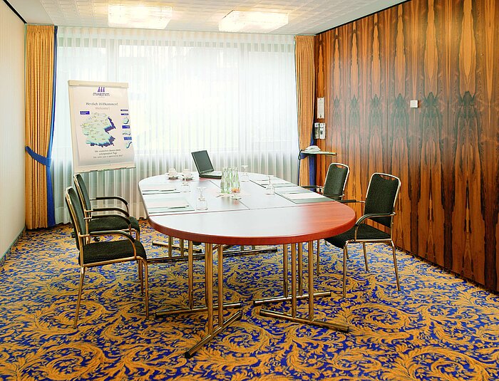 Bright meeting room with conference table at Maritim Hotel Bad Salzuflen for small meetings
